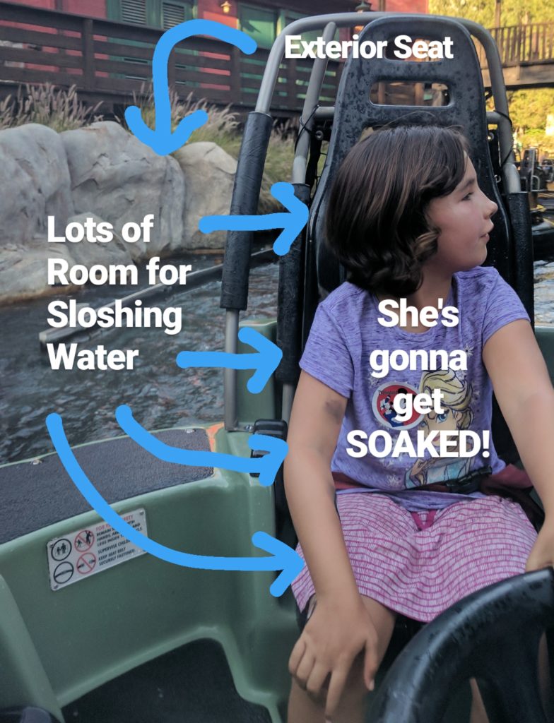 Girl looking off the screen toward the next part of the ride. She is sitting in an exterior seat on Grizzly River Run at Disney California Adventure. She will get soaked by the ride since she is sitting in an exterior seat.